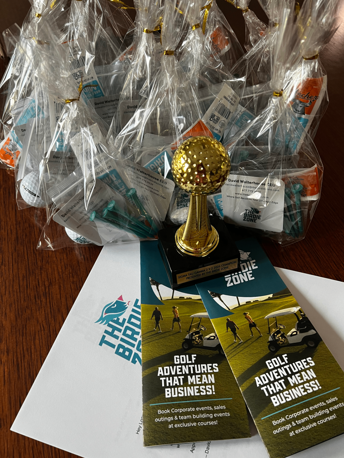 Branded Birdie Zone tee gifts, welcome bags, and a custom event trophy